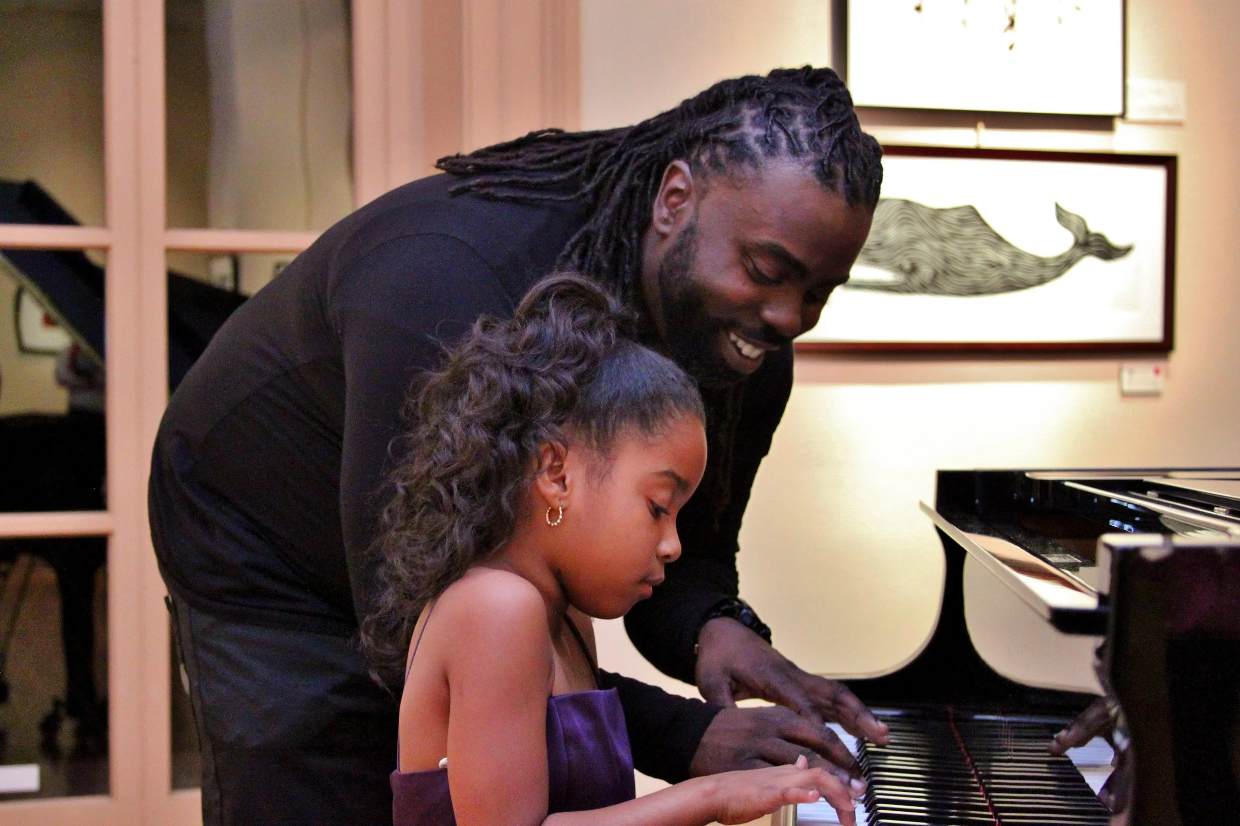 Paul Jerry Compere teaching a young student piano